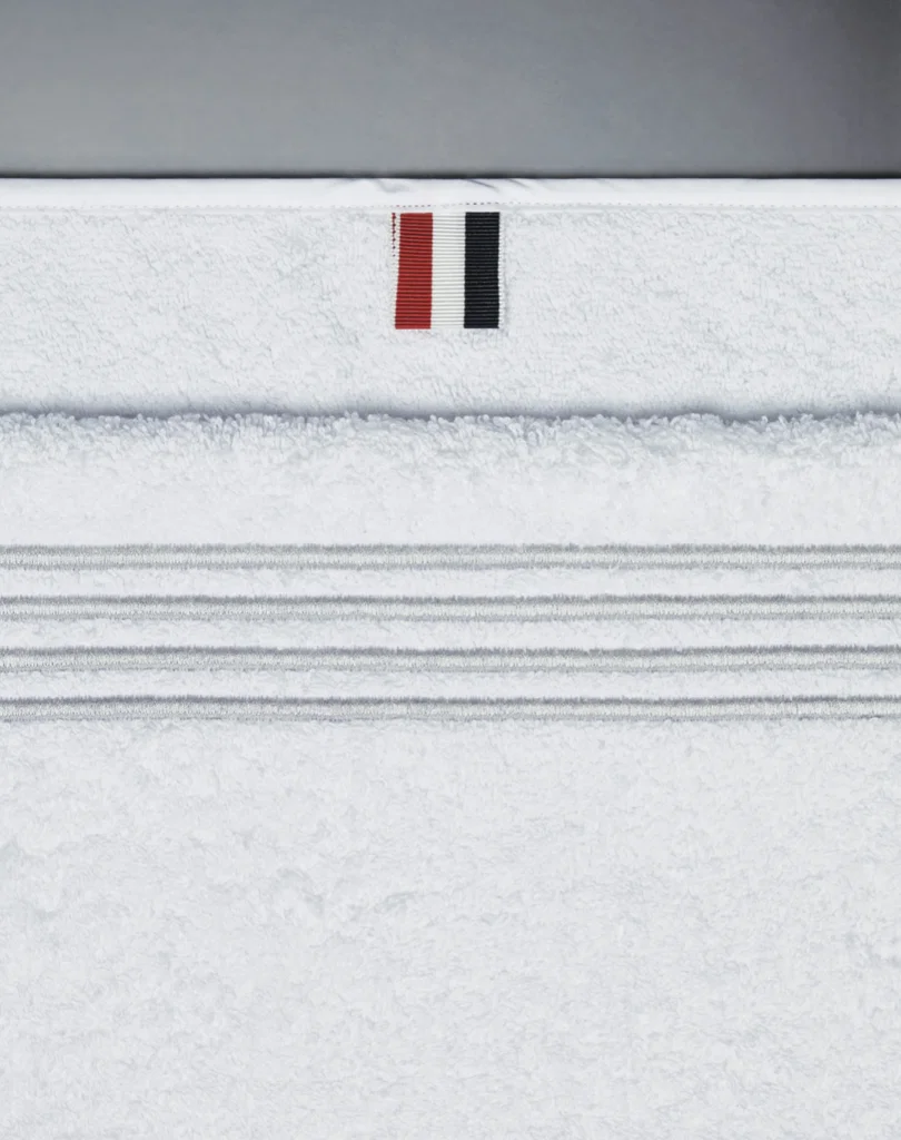 Gym towel with Thom Browne four-bar motif.