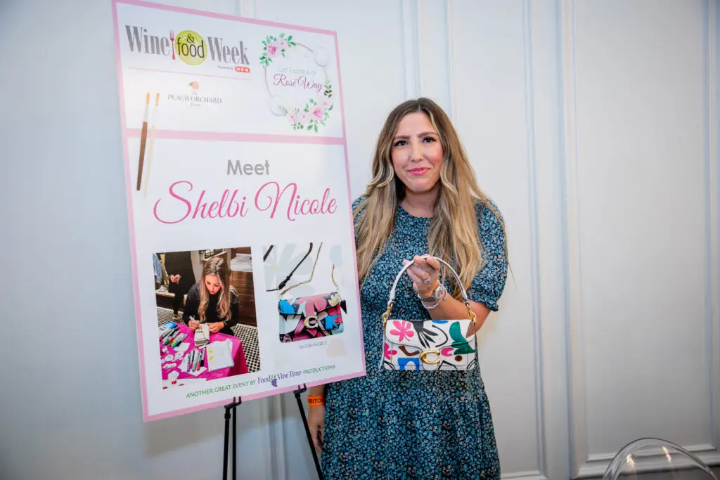 Artist Shelbi Nicole was on hand to hand paint a Coach bag at Rosé Way at the Peach Orchard.