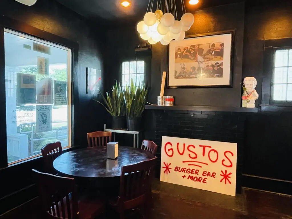 Pop art, spray paint and The King holding court inside GUSTOS Burger Bar + More. (Photo by Courtney Dabney)