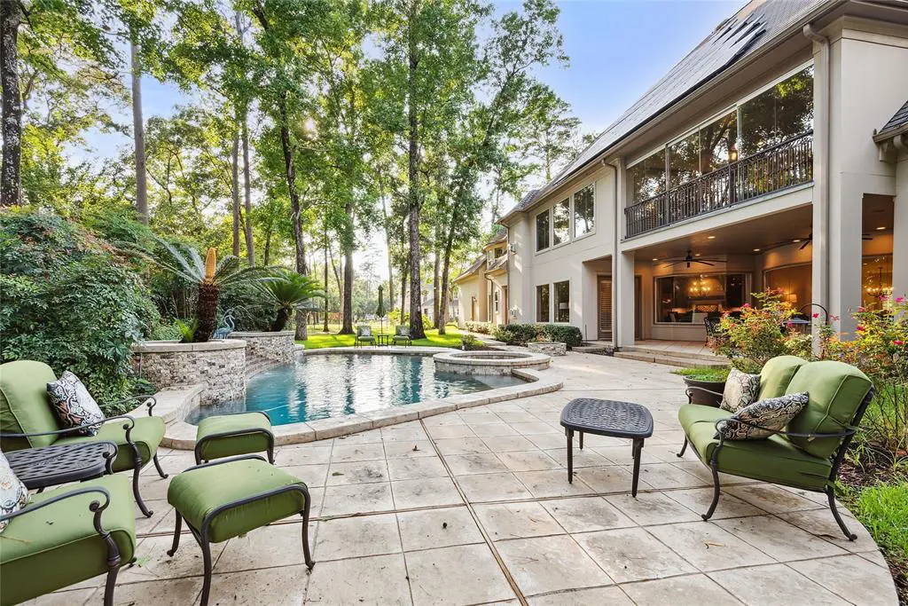 The peaceful backyard swimming pool area is a lovely place to relax on a hot summer's day at 235 Angel Leaf Road.