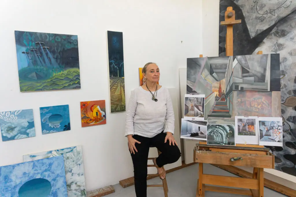 Arielle Masson surrounded by her paintings (Photo by Sofia Westerman) 