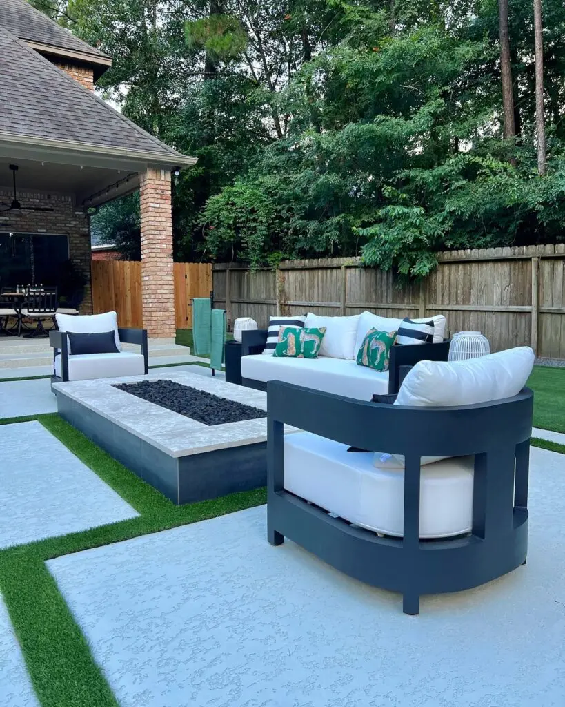 The large firepit area is one of Basso's favorite spots.  Lagasse pulled lush greens into the pillows to balance Basso's love of black and white.