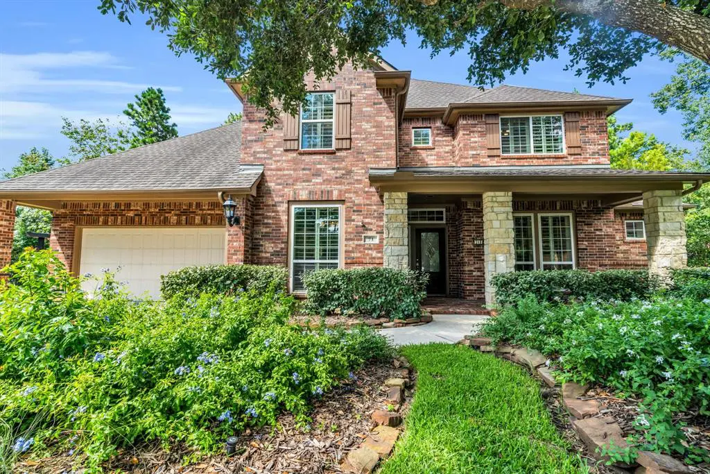 There is attractive landscaping at the front entrance of this inviting home. 
