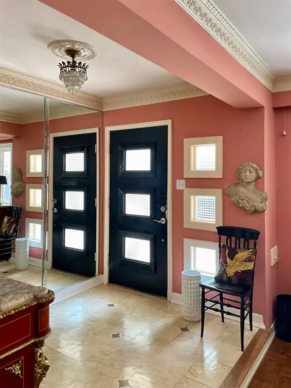 The elegant coral-hued entryway.  (Photo by Douglas Newby & Associates)