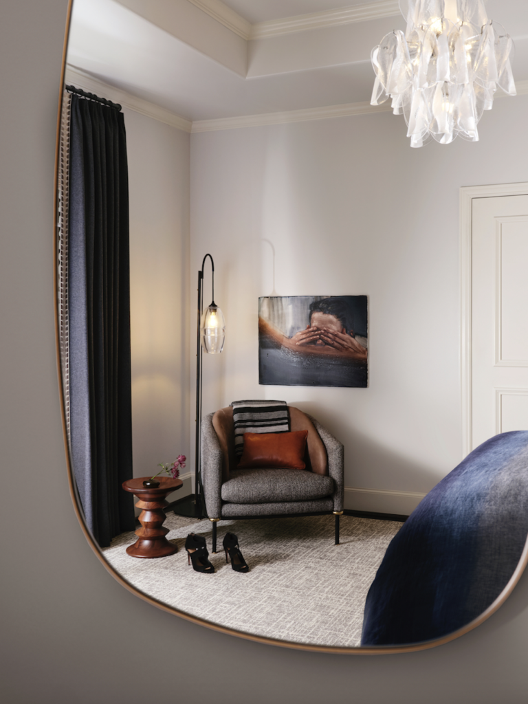 A side chair in the guest room is from Holly Hunt. Eames stool from DWR. Vintage Murano chandelier.  (Photo by Lisa Petrole)