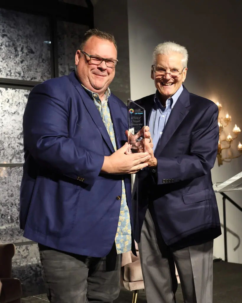 Honoree Chef Chris Shepherd with retired Houston Rockets play-by-play announcer Bill Worrell Jr. serving as emcee at the Family Houston luncheon.