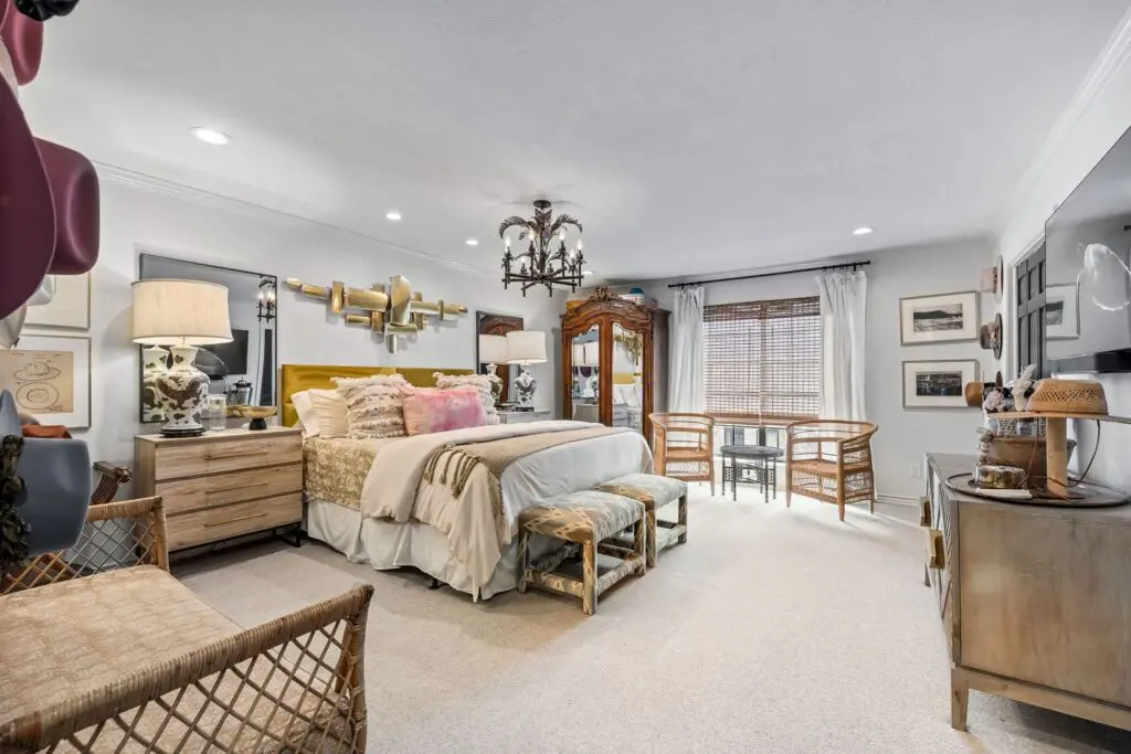 The primary bedroom features new carpet and a vintage chandelier sourced from Southern California. 