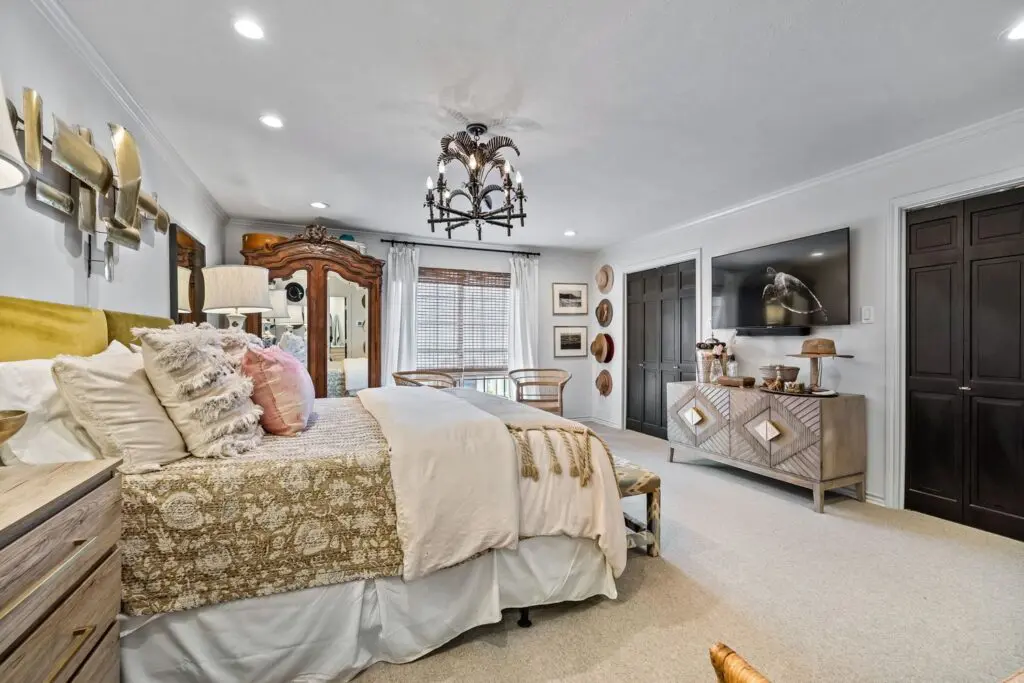 The primary bedroom features new carpet and a vintage chandelier sourced from Southern California. 