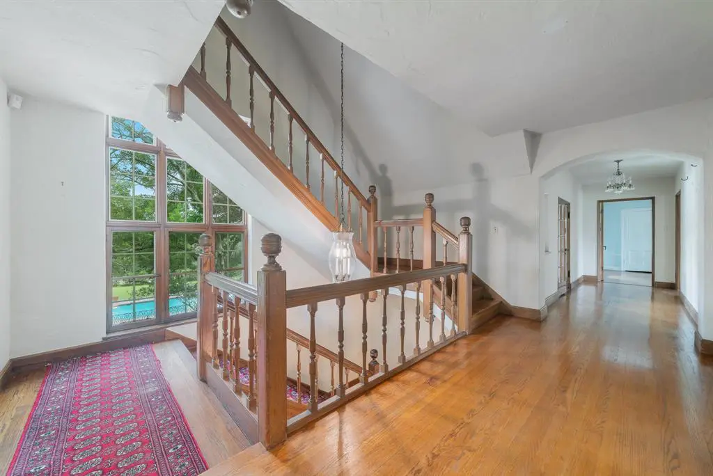Lofty windows light the way up the stairs. 