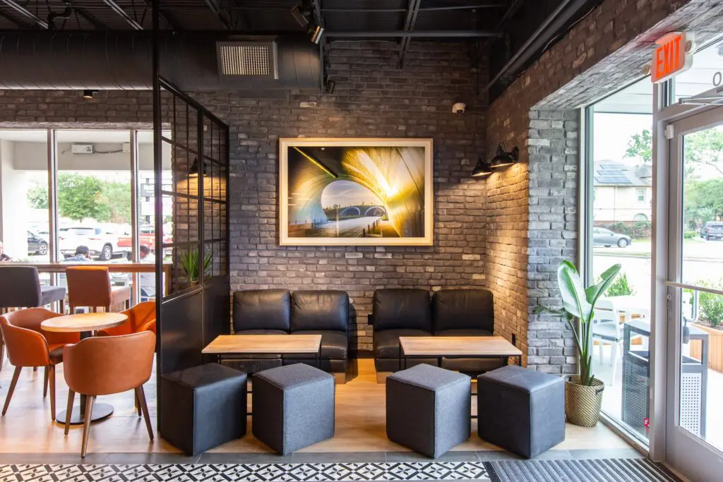 Another view of the European style cozy interiors of Coffee Fellows. The duo conjured the idea of crafting a European-style coffee shop while honeymooning in London. The thought was to build a cozy and inviting environment where customers could dash in for an espresso ($3.50/$4) or stay awhile and work, meet, or just relax over a flat white ($3.75) or a Chai matcha latte. Photo courtesy of Heirloom Interactive. 