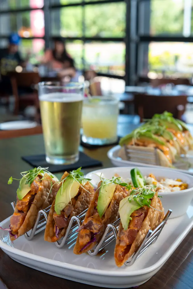 The crunchy ahi tuna tacos at Hearsay are served with ginger cilantro slaw, ponzu,
and creamy avocado, topped with gochujang aioli. Paired with a side of street corn casserole.
(Photo by Anthony Rathbun)