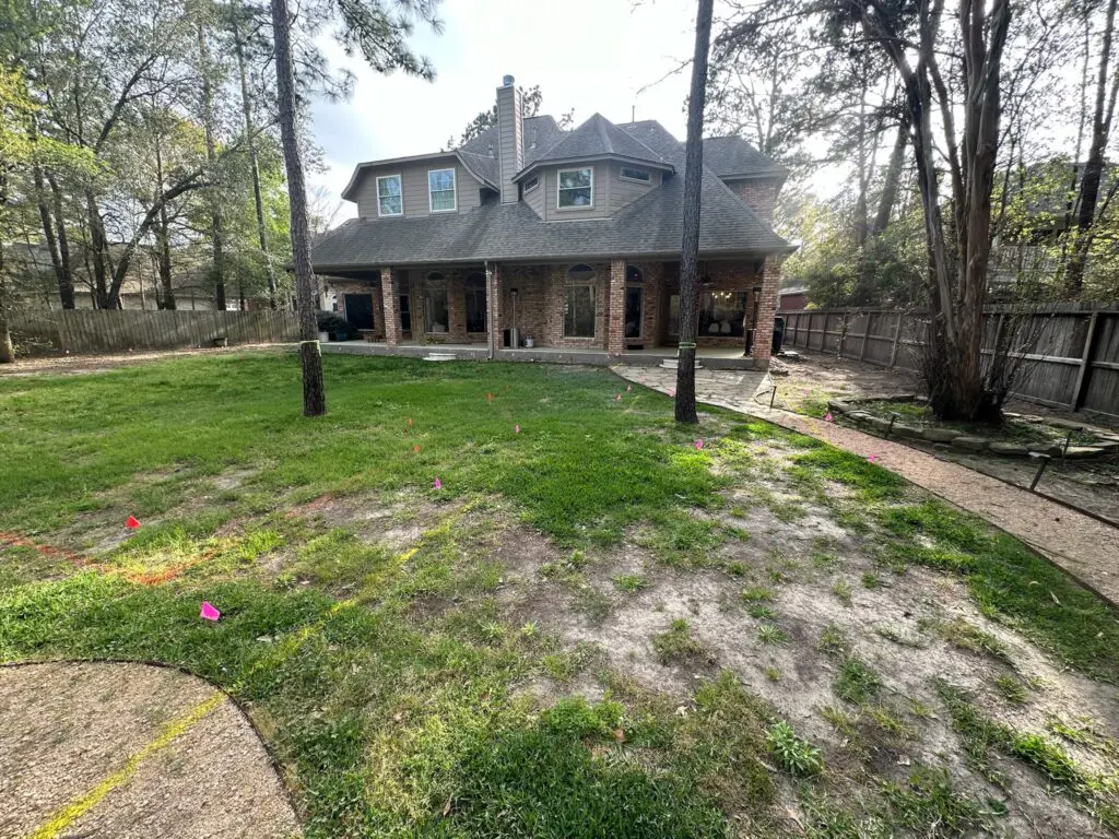 The "before" photo of the Basso's yard that shows the existing patio.