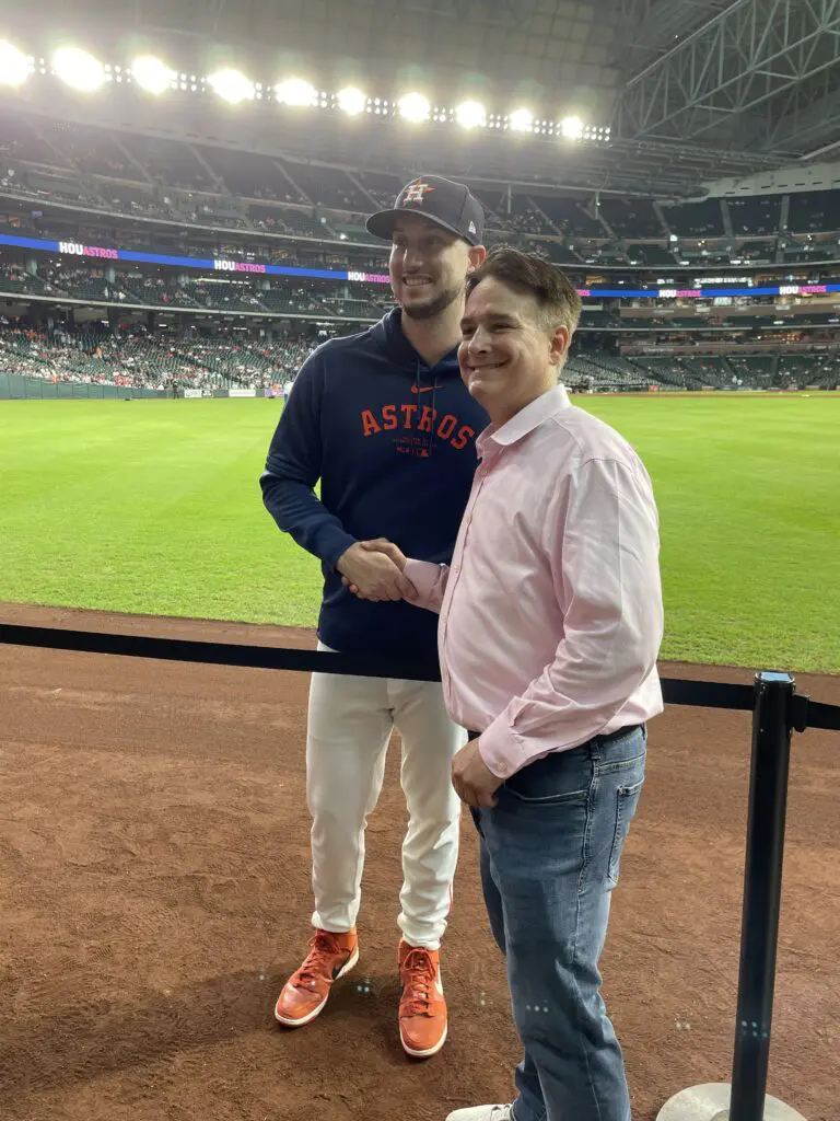 Kyle Tucker poses with a Houston Hospice supporter, right near where he usually patrols right field. Tucker is fighting to return from injury. (Photo by Kim Antley)