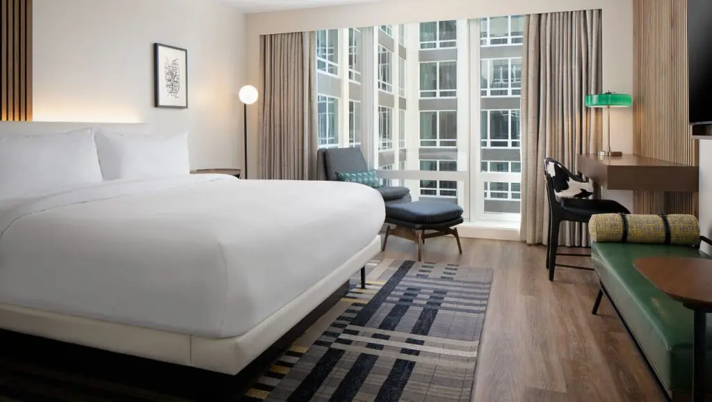 A King room with mid-century styling overlooking the courtyard at Le Mériden Fort Worth.