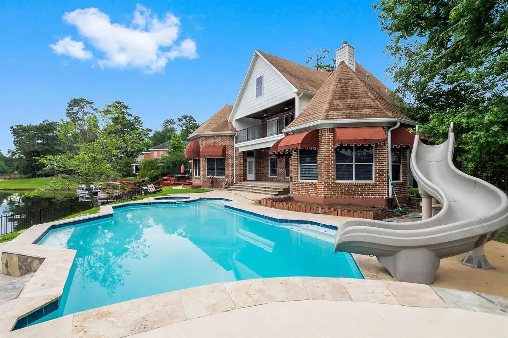 The pool area at this waterfront home in The Woodlands is perfect for family fun and endless sunny days. 