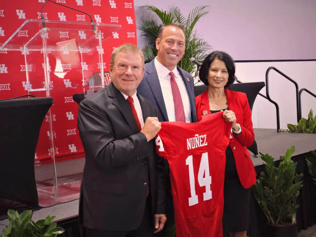 Tilman Fertitta, new University of Houston athletic director Eddie Nunez and Renu Khator have a UH moment. (Photo by F. Carter Smith)