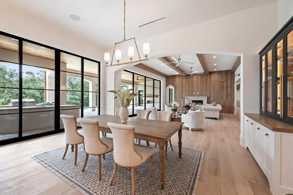 The focal wood wall and beams in the great room blend seamlessly with the kitchen.