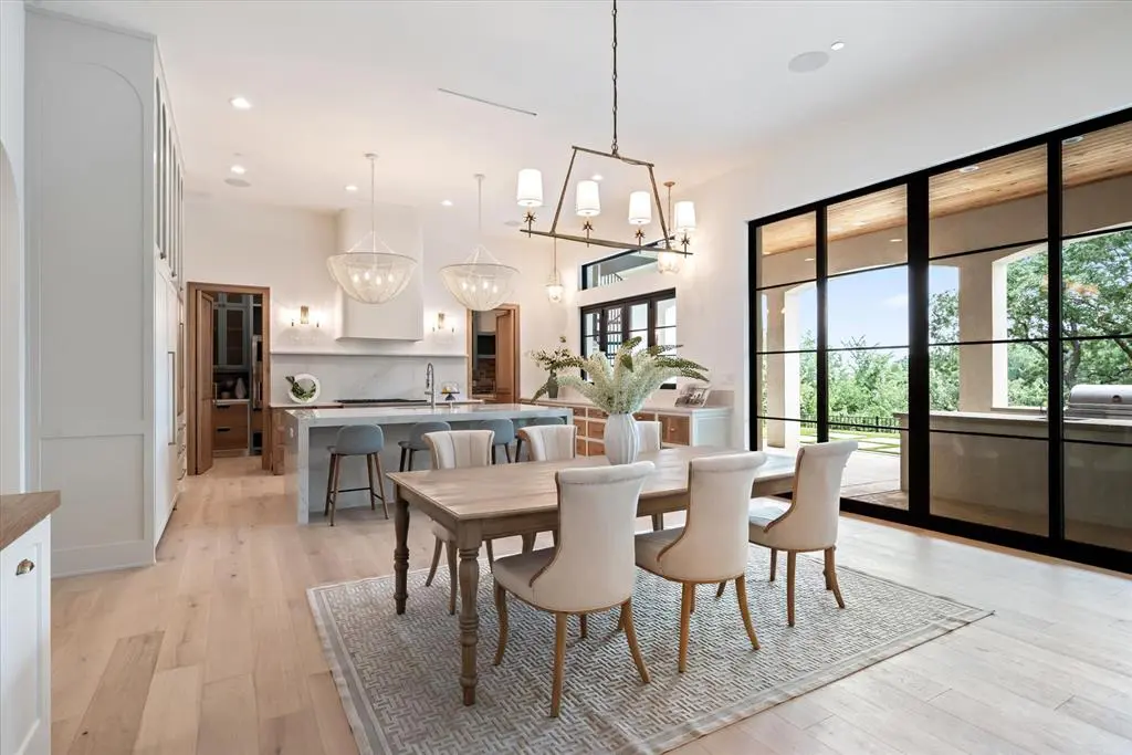 The kitchen takes in the sunny covered patio and peeks into the catering kitchen beyond the range wall.