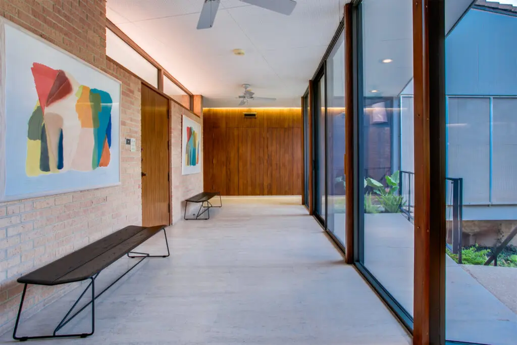 Travertine floors and walls of glass line the entrance.