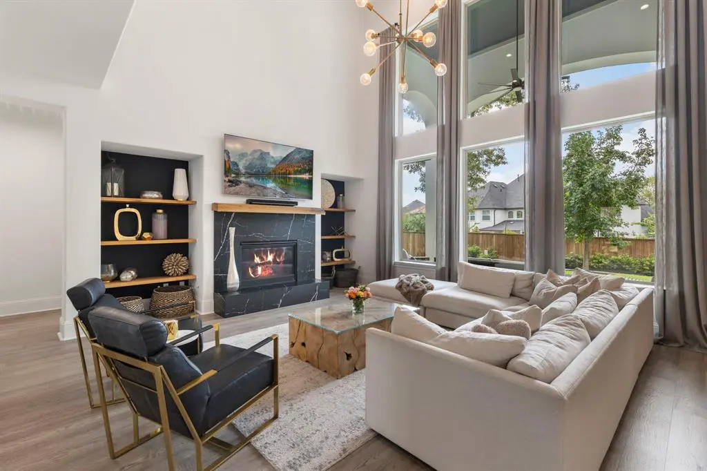 Tall ceilings and large windows allow for abundant natural light to flood through the open concept living space. 