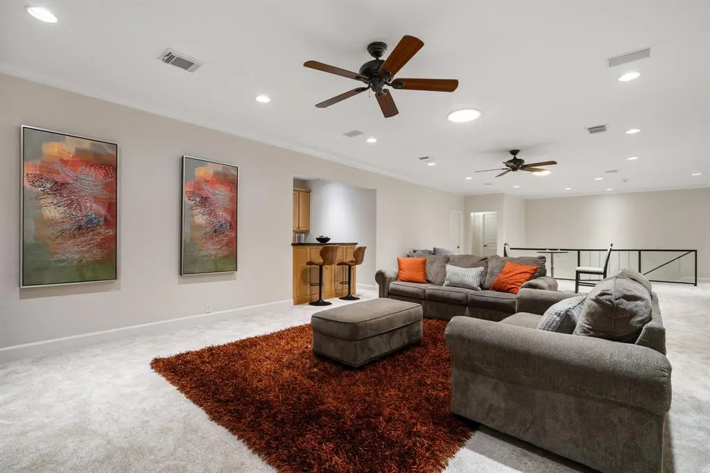 There are several bonus rooms to enjoy inside this home, including this game room with custom wet bar. 