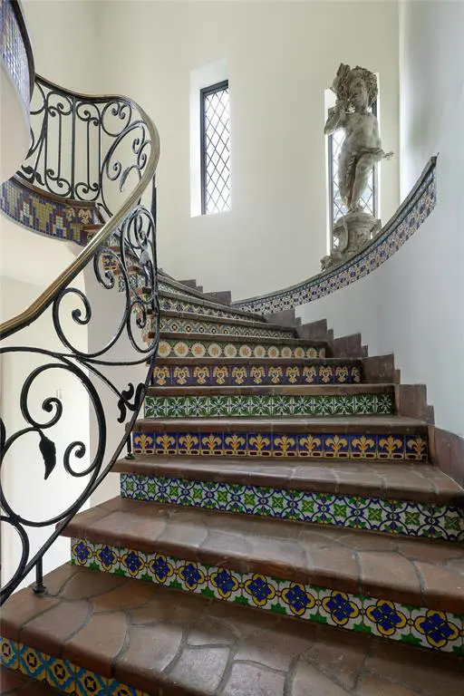 3828 Turtle Creek Drive boasts original details like the ironwork and tile on the staircase add historic appeal.