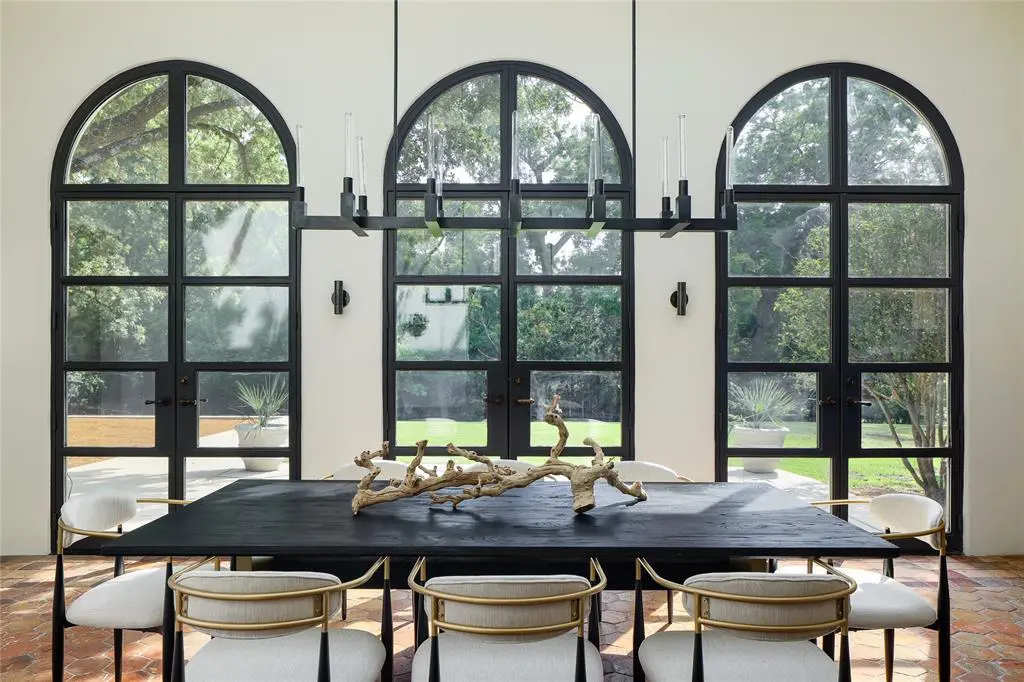 The solarium at 3828 Turtle Creek Drive is flooded with light from the glass skylight to sets of windows overlooking the manicured grounds.