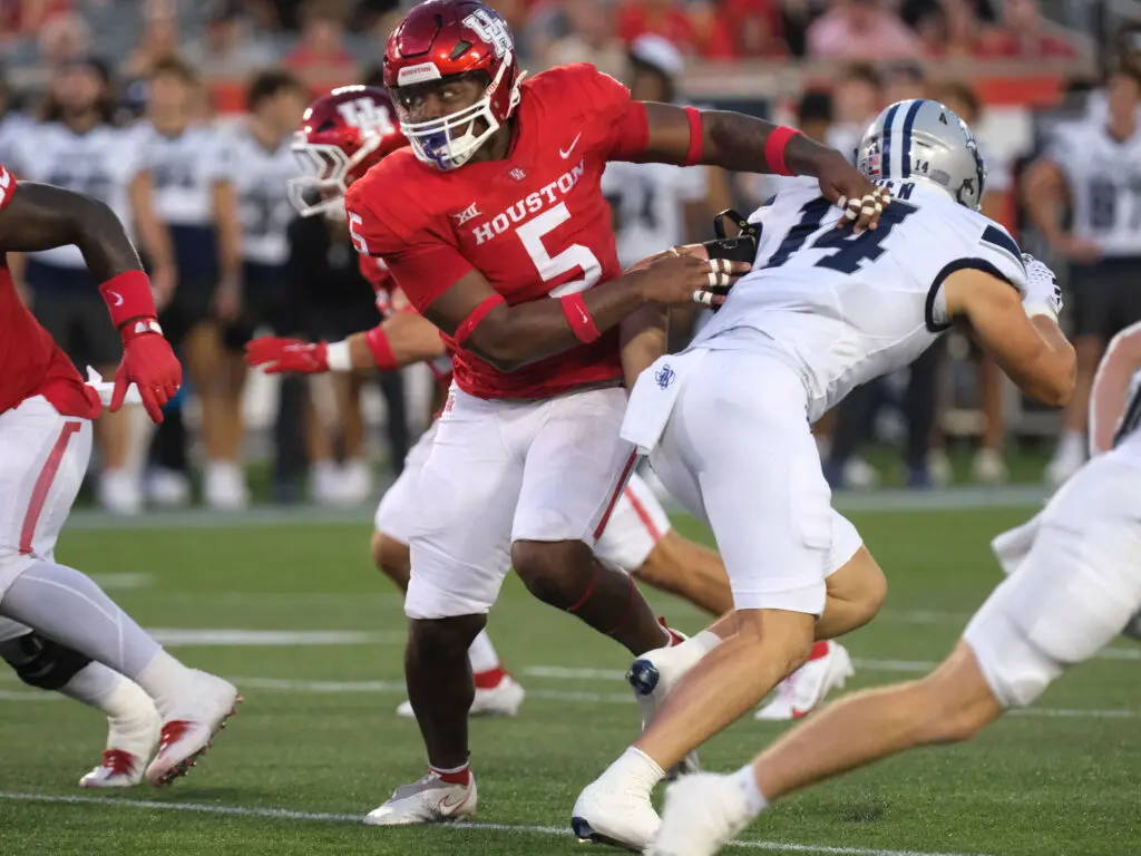 Keith Cooper Jr. has a way of brushing aside blockers as he purses quarterbacks for the University of Houston. (Photo by F. Carter Smith)