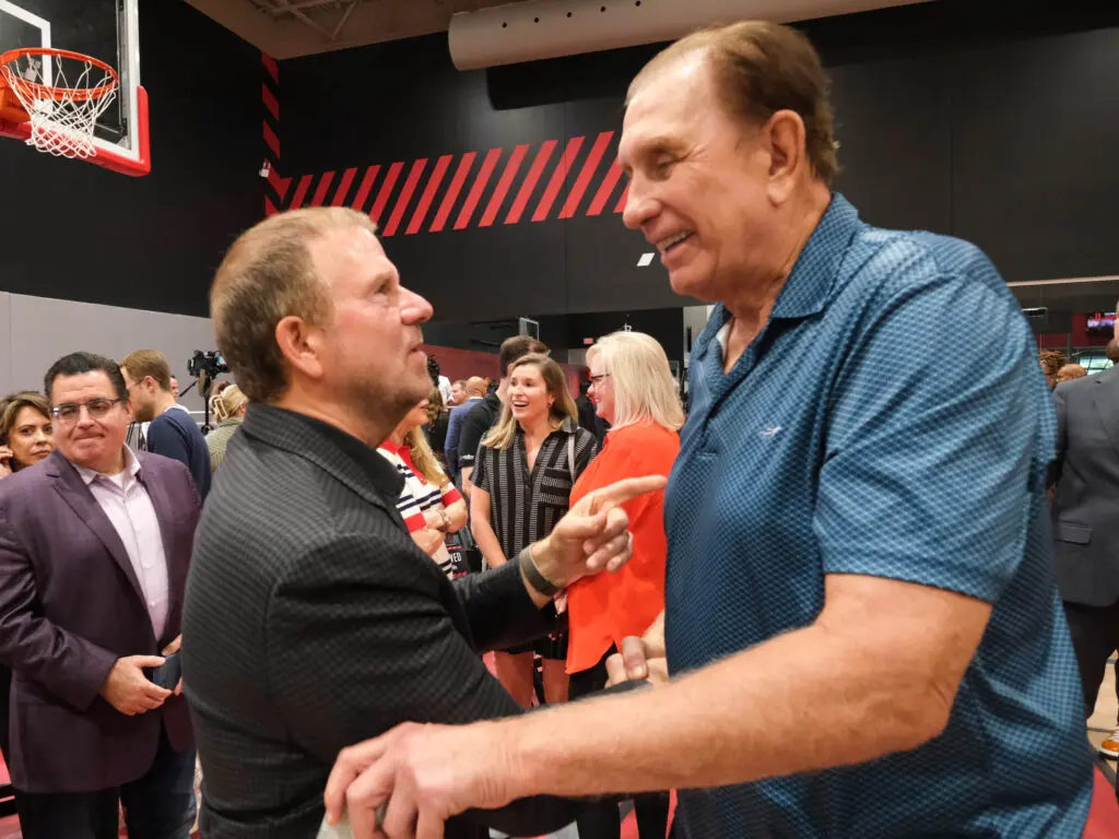 Houston Rockets owner Tilman Fertitta gave Rudy Tomjanovich a warm greeting. (Photo by F. Carter Smith)