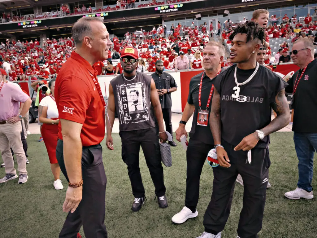 New university of Houston athletic director Eddie Nuñez brings plenty of enthusiasm as Coog turnd Texans star Tank Dell found out. (Photo by F. Carter Smith)