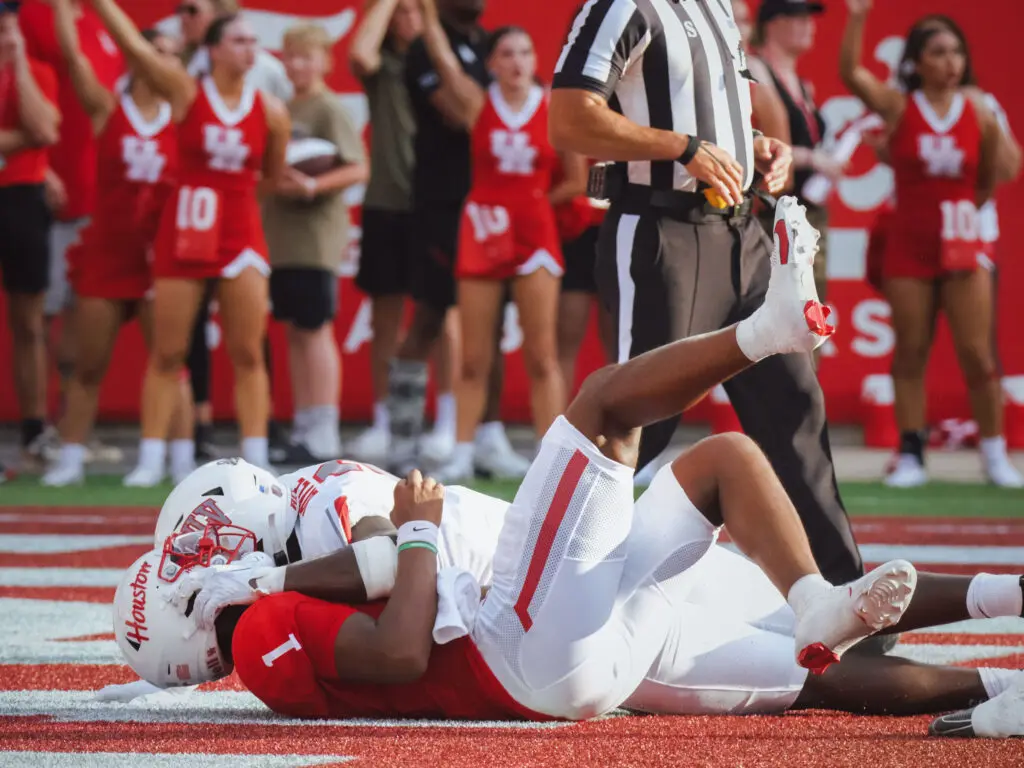 University of Houston quarterback Donovan Smith will take the punishment to try and make a play. (Photo by F. Carter Smith)