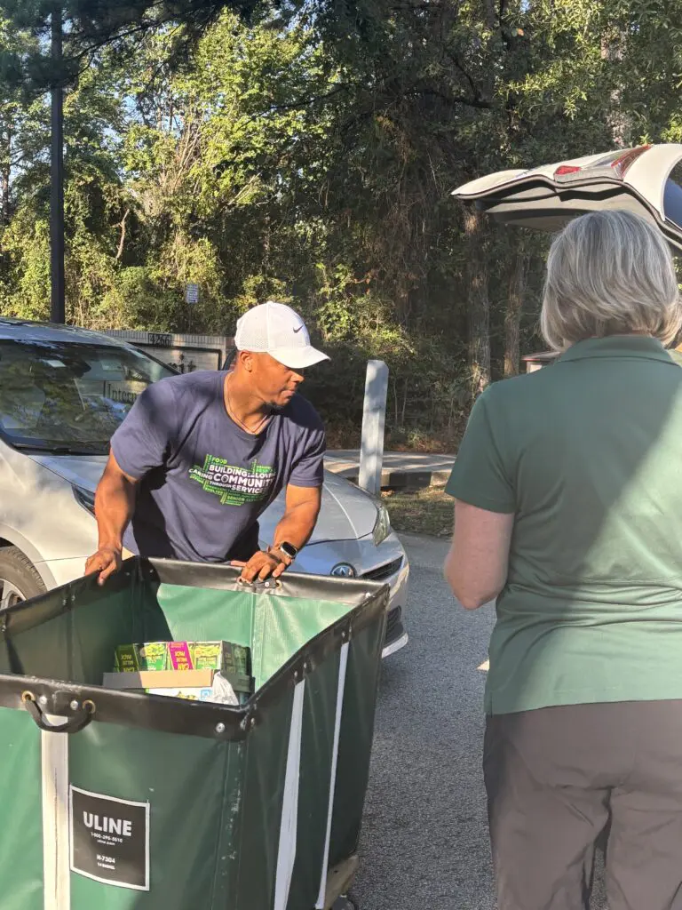 Interfaith personnel unloaded cars with donations for the food pantry on the "Day of Giving" during the 50th anniversary celebration week. (Photo by Laura Landsbaum)