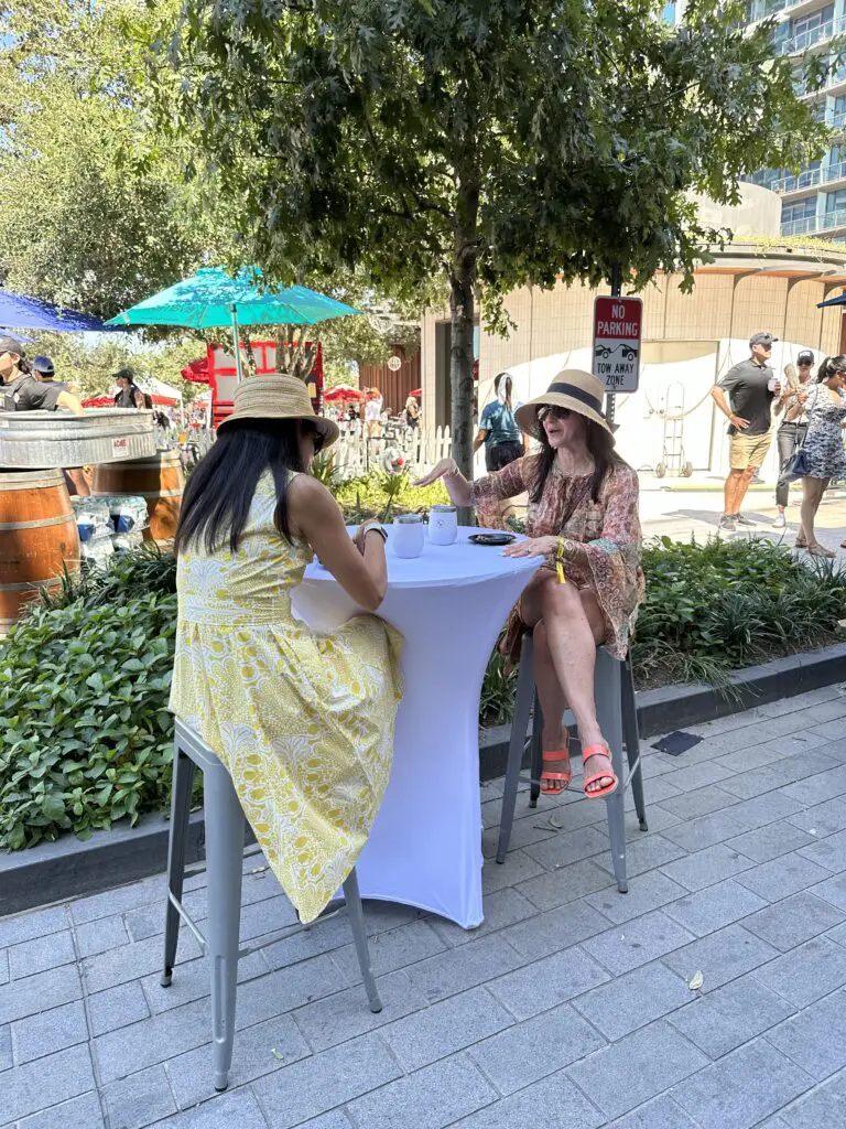 Sitting in the shade while sampling taste treats at the Houston Chefs for Farmers event. (Photo by Shelby Hodge)