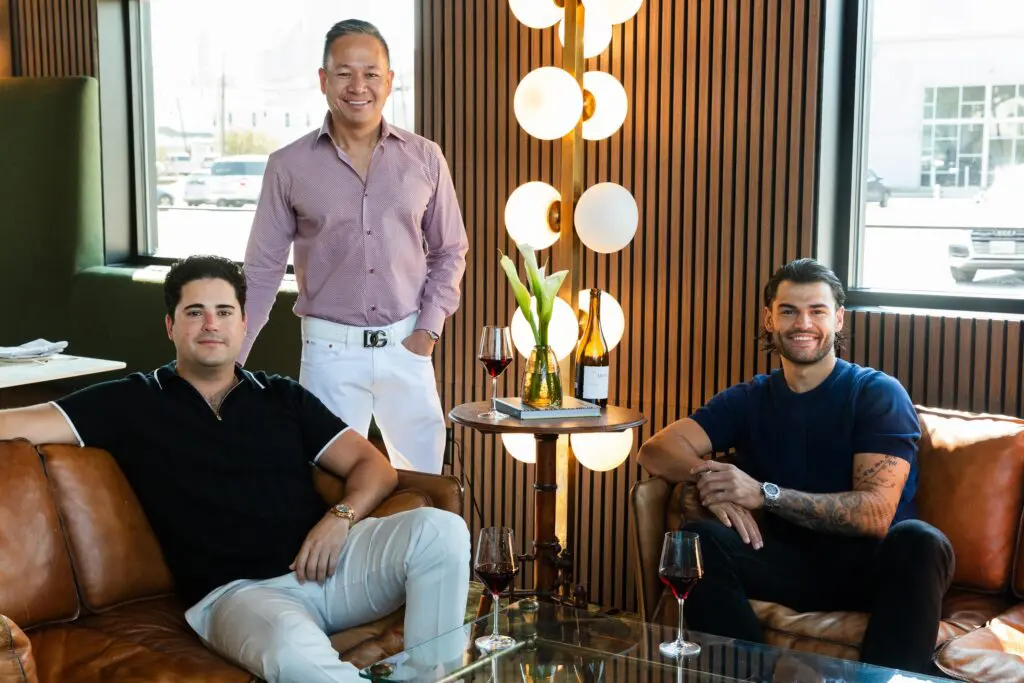 Rex Hospitality's owners Juan Carlos de Aldecoa, Jimmy Doan and Lance McCullers Jr. hang out in the new Maven's waiting area. (Photo by Becca Wright)
