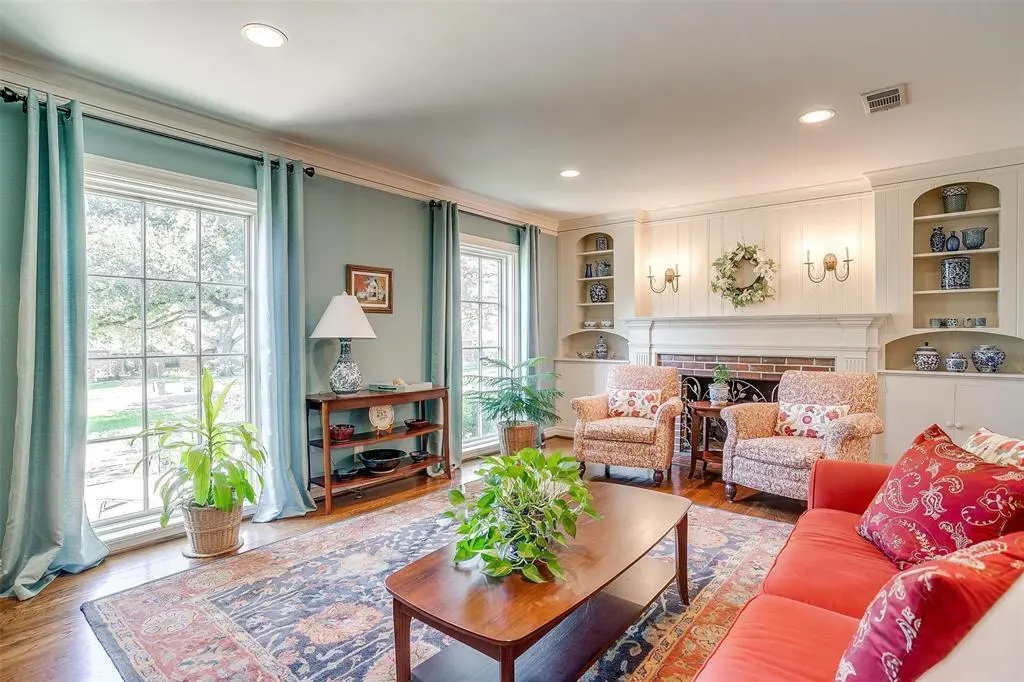 3241 Westcliff Road West sports original hardwoods and period details include the book shelves flanking the fireplace.