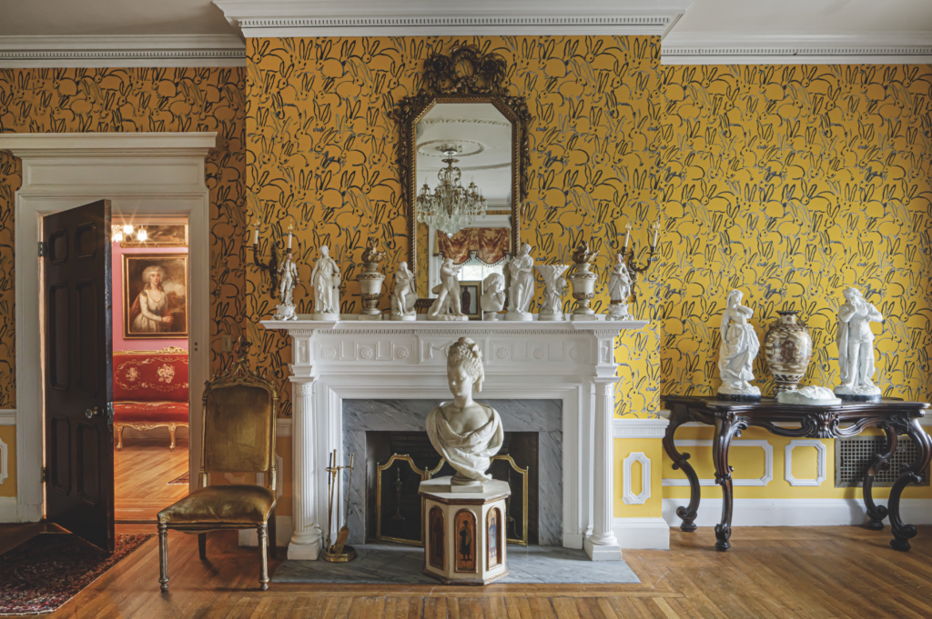 A bright yellow "Hutch" wallpaper for Lee Jofa brightens a bedroom in artist Hunt Slonem's restored Belle Terre, South Kortright, New York. The artist is one of America's greatest restorationists, with a tremendous portfolio of historic and important properties. (Photo by John Neitzel)