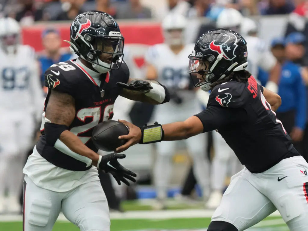 C.J. Stroud handing off to Joe Mixon helps keep this Texans offense going. (Photo by F. Carter Smith)