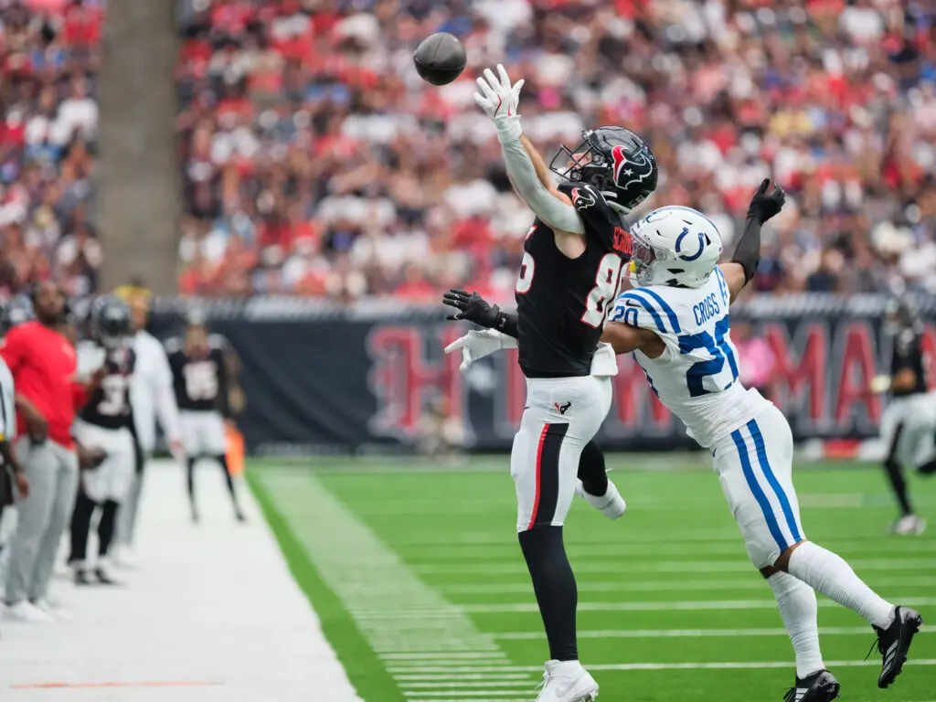 Reaching for the pass however you can is part of the NFL life. (Photo by F. Carter Smith)