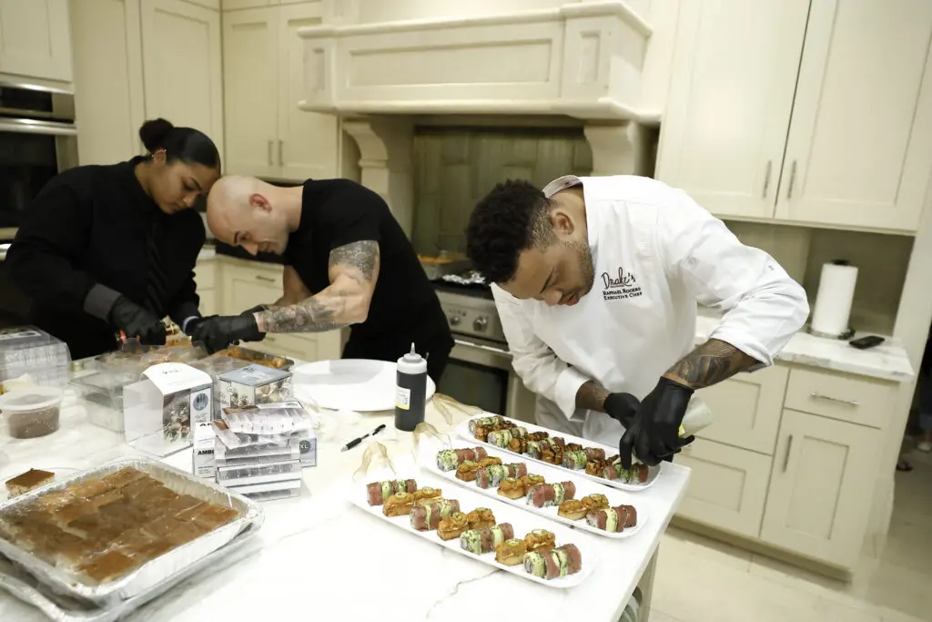 Staff from Drake's Hollywood preparing hors d'oeuvres for guests  at Amir Taghi's trunk show in the family home in Tanglewood  (Photo by Quy Tran)