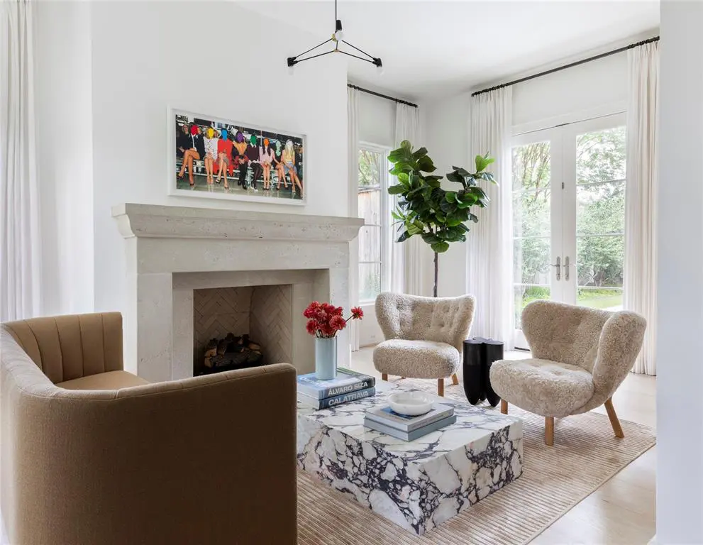 The residence enjoys several areas for entertaining including this more formal area with fireplace.