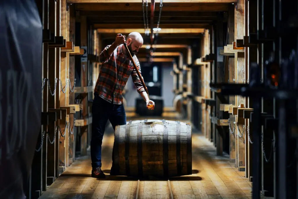 In the barrel room with a whiskey thief at Angel's Envy Distillery in Louisville, Kentucky. (Photo by Robert J. Lerma)
