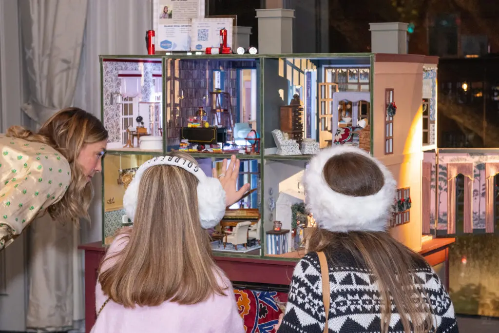 Guests inspecting the fine art of dollhouse design at La Petite Maison (Photo by Jacob Power)
