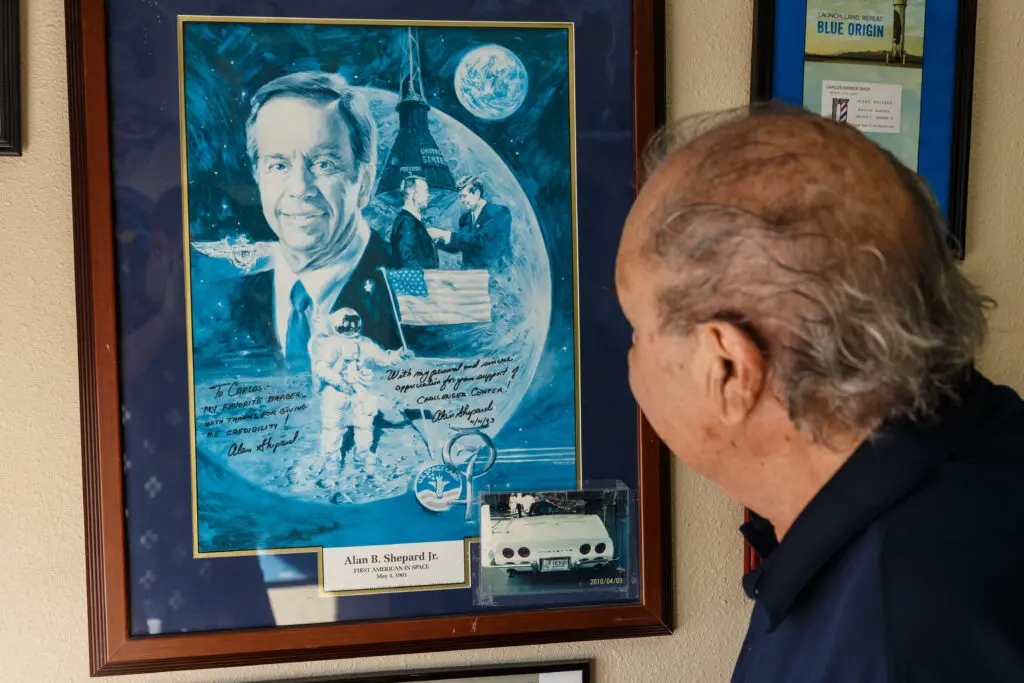 Villagomez's barber shop is adorned with cherished space artifacts and notable photos, each one a story he's proud to share.