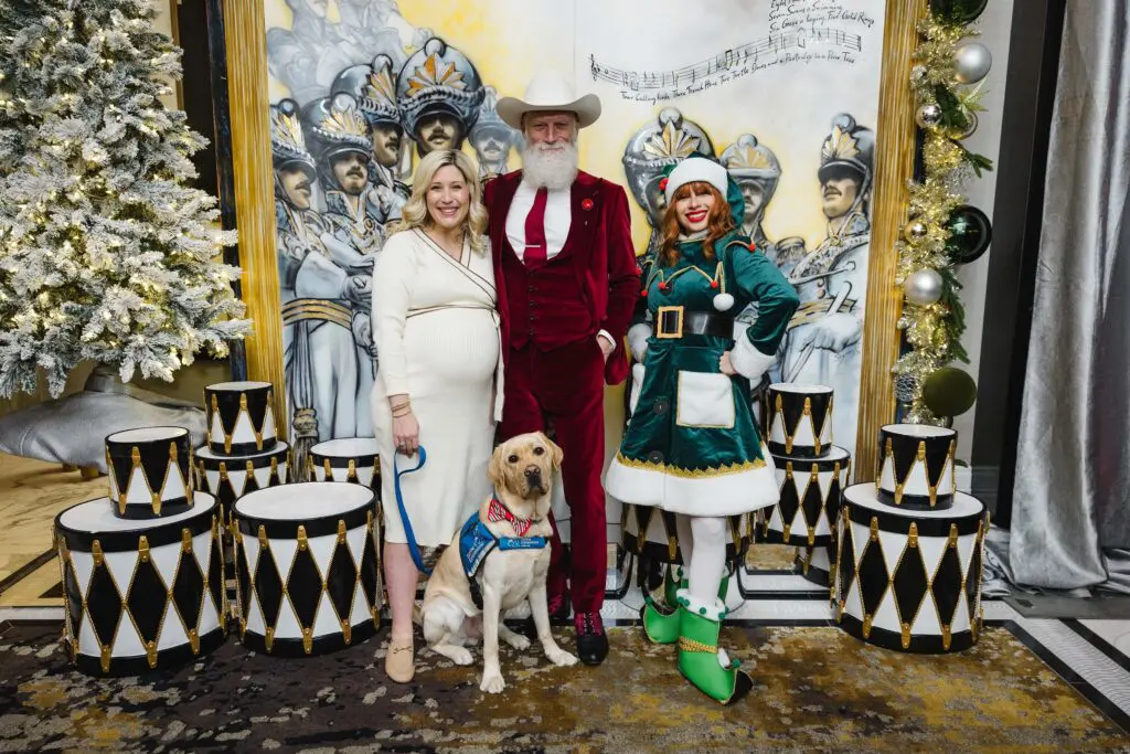 Child Life specialist Adair Winget , Pawsitive Play dog Melman, Fashion Santa and an Elf at the Ambassadors for Texas Children's Hospital holiday party. (Photo by Johnny Than)