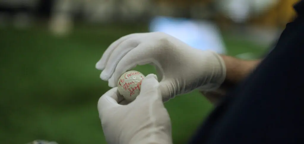 Rob Pearlman examines the infamous third golf ball to decipher unanswered questions. (Photo courtesy of Barbara Radnofsky)