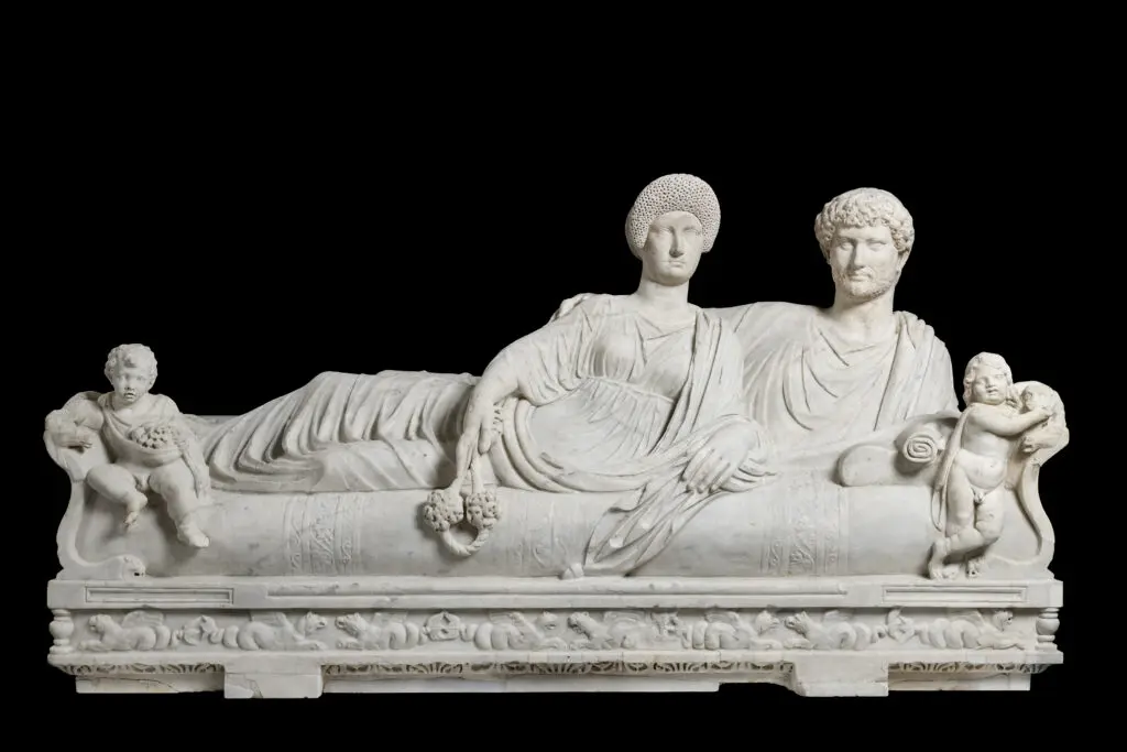 "Lid with Reclining Couple" is a poignant representation of eternal companionship in Roman funerary art. (Courtesy of Torlonia Foundation)