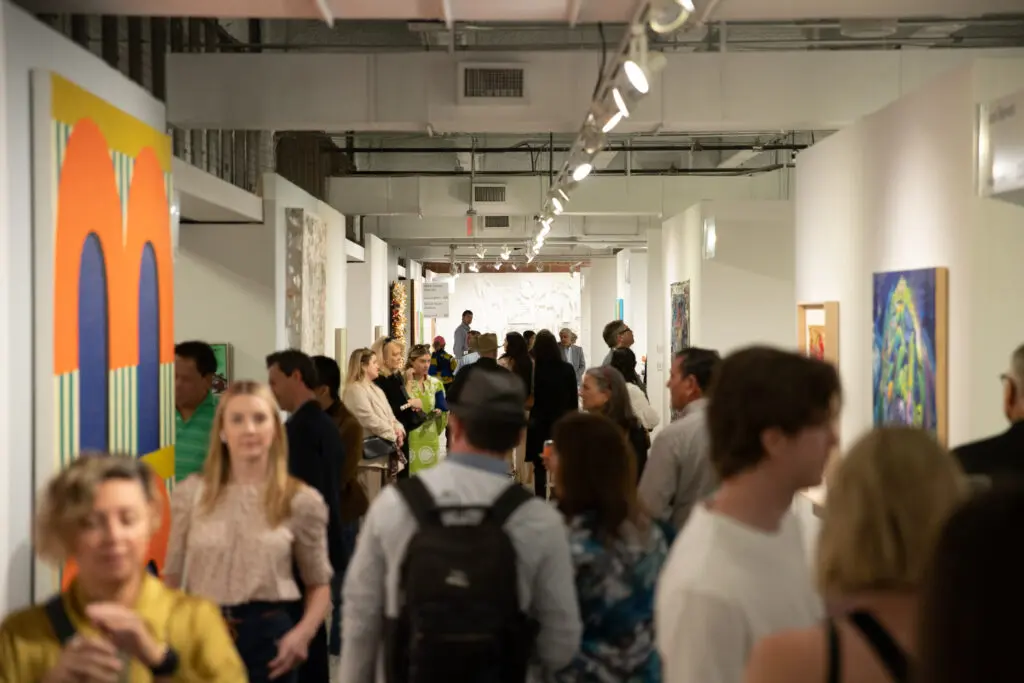 Perusing booths at Dallas Art Fair VIP Preview Day 2024. The 2025 edition of Dallas Art Fair takes place April 10 – 13, at Fashion Industry Gallery. Collectors note: Preview Benefit is Thursday, April 10, 5 to 9 pm. (Photo by Exploredinary)