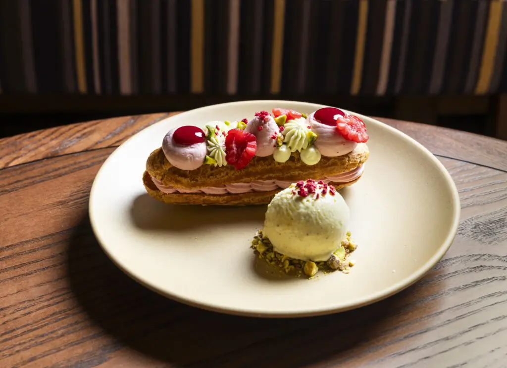 The pastry program at Perseid is headed by skillful chef Marie Riddle, who balances crave-worthy sweets such as chocolate entremet (essentially a rich devil’s-food-like layer cake embellished with salted caramel and a quenelle of coffee ice cream, $13) with an elegant éclair filled with bright raspberry ganache and pistachio ice cream ($13). (Photo by Julie Soefer)