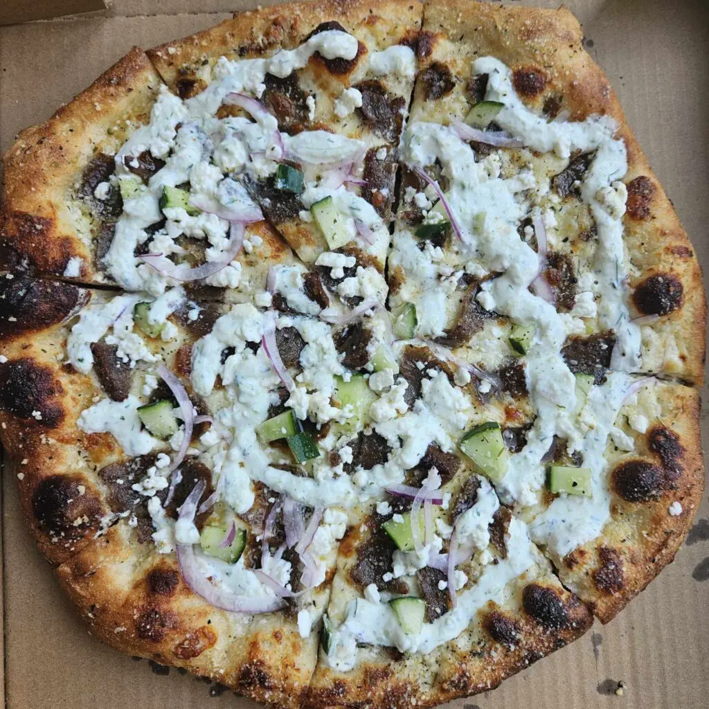 Baked Pizzeria’s pop-ups at The Black Rooster Bakery serve inventive, from-scratch pizzas like the All-American and the must-try Gyro Pizza, loaded with bold Mediterranean flavors. (Photo by Edward Brown)