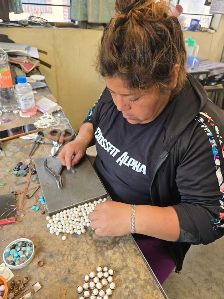 Leticia Chaparro carefully organizes pearls, each one selected with care for its unique beauty. Every stone plays a crucial role in bringing each handcrafted piece to life. (Photo courtesy Gabriela Torres Zaragoza)